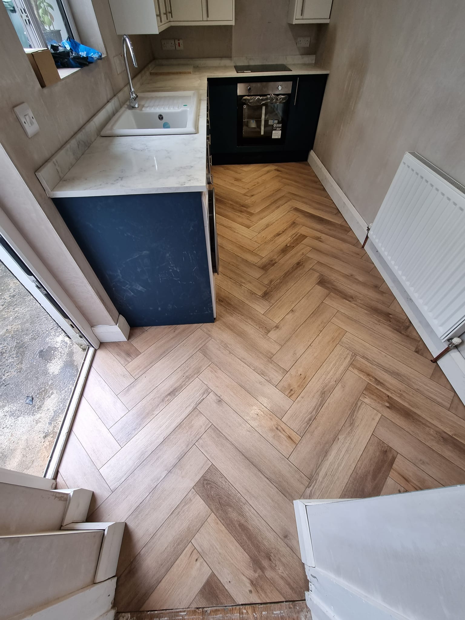 Small kitchen with herringbone floor