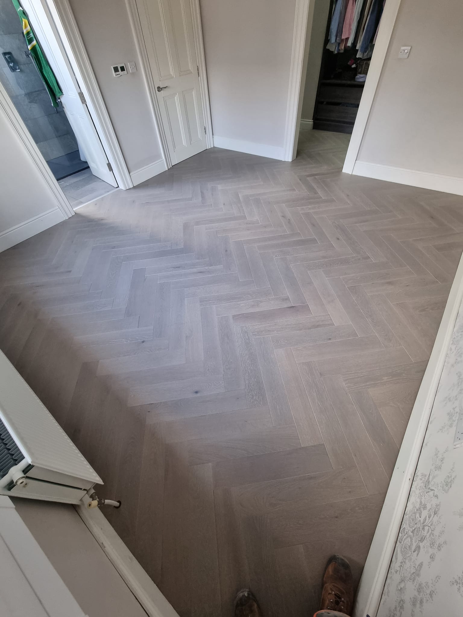 herringbone wooden floor in a bedroom