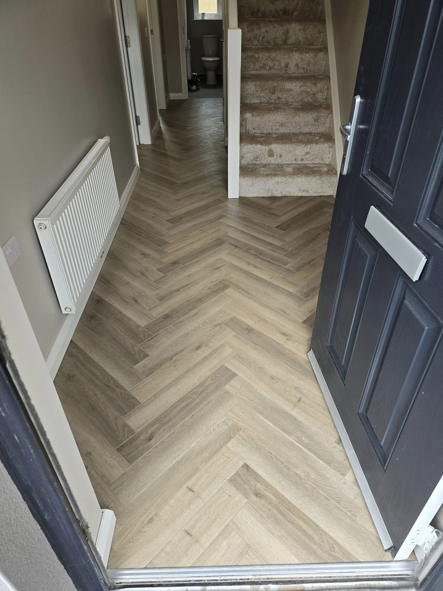 Entrance hall with herringbone style laminate