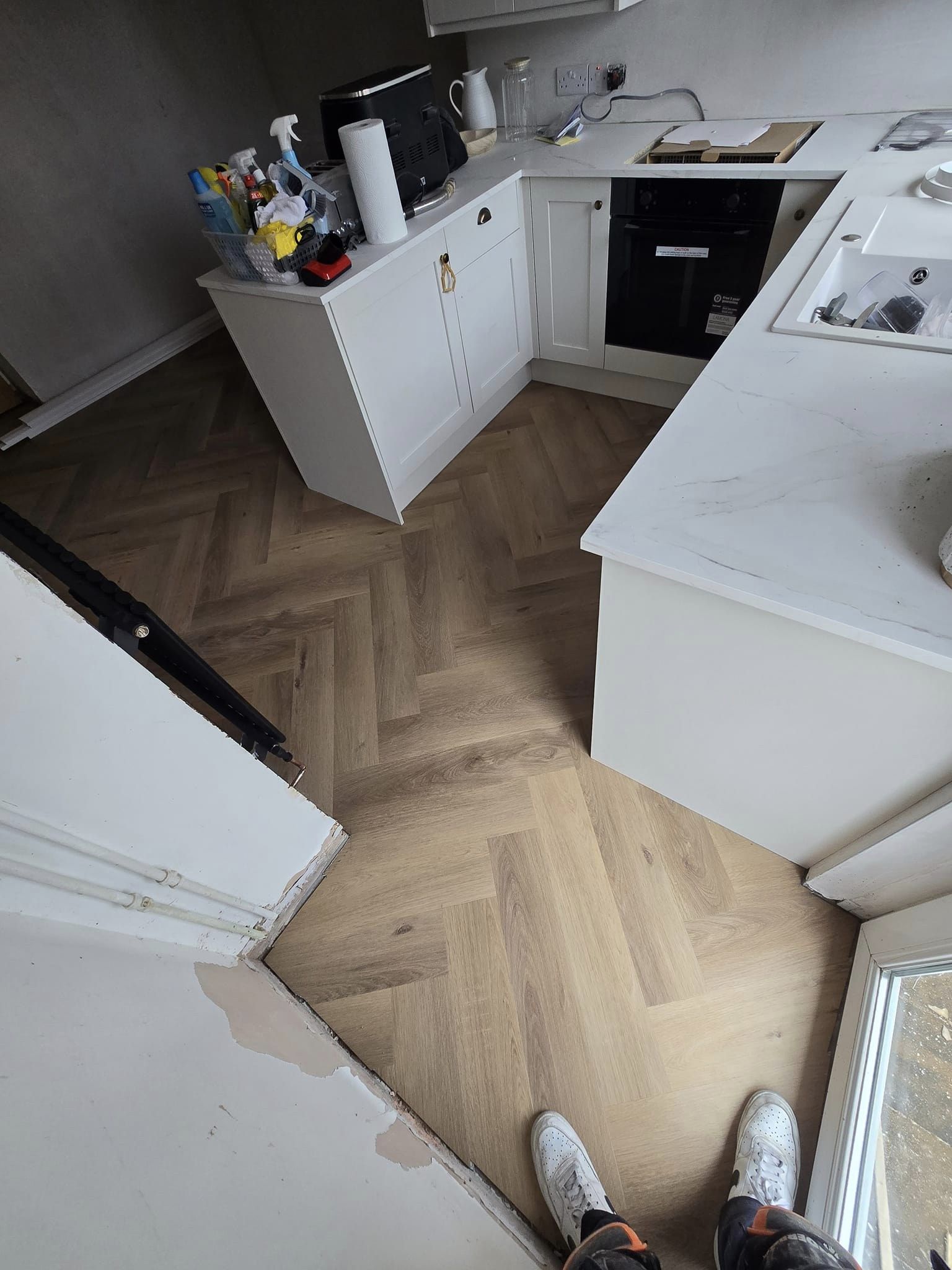 fitting herringbone flooring in a kitchen